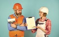 Sign contract with workers. Price list. Couple look documents. Couple planning changes renovation apartment. Renovation Royalty Free Stock Photo