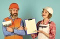 Sign contract with workers. Price list. Couple look documents. Woman and man safety hard hat. Discussing renovation with Royalty Free Stock Photo