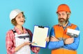 Sign contract with workers. Price list. Couple look documents. Woman and man safety hard hat. Discussing renovation with Royalty Free Stock Photo