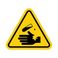 Sign of corrosive substance. Warning sign corrosive substance. Yellow triangle sign with hand icon and test tube inside. Danger, Royalty Free Stock Photo