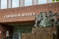 the sign of a courts of justice or magistrates court with the royal crest next to the sign Royalty Free Stock Photo