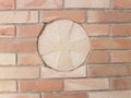 Sign of the cross on a brick wall masonry. Artistic and religius sign. Europen cevilisation. Royalty Free Stock Photo