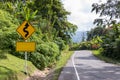 Sign curved road on the way at the natural Field Or forest. Warning attention Right curve sign at Rural highway. Road sign showing Royalty Free Stock Photo