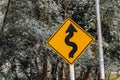 Sign curved road on the way at the natural Field Or forest. Warning attention Right curve sign at Rural highway. Royalty Free Stock Photo