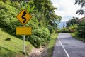 Sign curved road on the way at the natural Field Or forest. Warning attention Right curve sign at Rural highway. Road sign showing Royalty Free Stock Photo