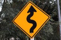 Sign curved road on the way at the natural Field Or forest. Warning attention Right curve sign at Rural highway. Royalty Free Stock Photo