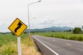 Sign curved road on the way at the natural  Field Or Meadow. Warning attention Right curve sign at Rural highway. Road sign showin Royalty Free Stock Photo