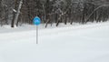 Sign `Cycle trail` against the background of snow-covered forest.
