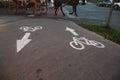 Sign cyclist and the direction arrow on the background of asphalt road Royalty Free Stock Photo