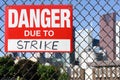 Sign danger due to strike hanging on the fence Royalty Free Stock Photo