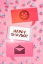 Sign displaying Happy Shavuot. Word Written on Jewish holiday commemorating of the revelation of the Ten Commandments