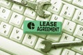 Sign displaying Lease Agreement. Word for Contract on the terms to one party agrees rent property Typing Character