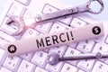 Sign displaying Merci. Word for thank you in French what is said when someone helps you in France