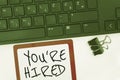 Sign displaying You Re Hired. Word for New Job Employed Newbie Enlisted Accepted Recruited Computer Keyboard And Symbol