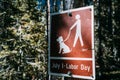 Sign for dogs allowed on the trail if they are leashed during the summer months