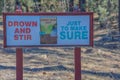 Sign - Drown and Stir, Just to Make Sure. Near Overgaard in Sitgreaves National Forest, Navajo County, Arizona USA Royalty Free Stock Photo