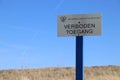 Sign with dutch text Verboden toegang which means in English no admittance of the water authority Delfland in the dunes of Monster