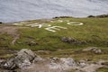 Sign 80 EIRE made of white rocks on a green field by the ocean. Malin head, county Donegal, Ireland Royalty Free Stock Photo