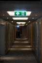 Sign : Emergency exit sign at path way indoor building public facility that emergency escape route is left Royalty Free Stock Photo