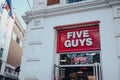 Sign by the entrance to Five Guys restaurant in London, UK