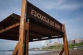 Sign with Escuela de surf inscription means Surfing school from Spanish. Serfing school shelter located in Mar del Plata
