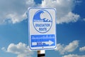 Sign an evacuation route at danger of a tsunami. Royalty Free Stock Photo