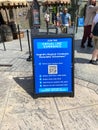 A sign explaining the virtual line system at Universal Studios outside the Hagrid`s Magical Creatures Ride Royalty Free Stock Photo