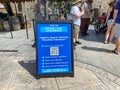 A sign explaining the virtual line system at Universal Studios outside the Hagrid`s Magical Creatures Ride Royalty Free Stock Photo
