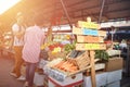 Sign for fresh and organic vegetables  at the green market or farmers market stall.  Young buyers choose and buy products for Royalty Free Stock Photo