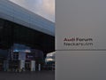 Sign in front of main entrance of futuristic Audi Forum Neckarsulm operated by automotive manufacturer Audi.