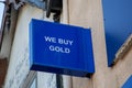 A sign on the front of a pawnbrokers saying we buy gold Royalty Free Stock Photo