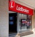 Sign and front window display of a ladbrokes betting shop on the headrow in leeds west yorkshire