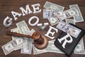 Sign Game Over, Doolars Cash, Judges Gavel On Wood Background Royalty Free Stock Photo