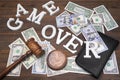 Sign Game Over, Doolars Cash, Judges Gavel On Wood Background Royalty Free Stock Photo