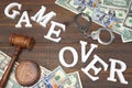 Sign Game Over, Money, Handcuffs, Judges Gavel On Wood Background Royalty Free Stock Photo