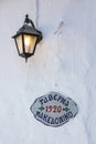 Sign of greek tavern on a white wall