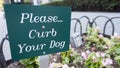 Sign, green white, Please curb your dog, city sidewalk, walkway