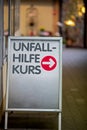 Sign with guide to the first aid class, text in german language Unfall Hilfe Kurs, translated first aid class Royalty Free Stock Photo