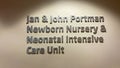 A sign in a hallway the says Jan and John Portman Newborn Nursery and Neonatal Intensive Care Unit