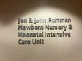 A sign in a hallway the says Jan and John Portman Newborn Nursery and Neonatal Intensive Care Unit