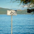 Sign for a handicapped accessible beach on the otherwise rocky coast near Krk in Croatia