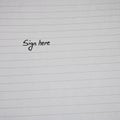 Sign here, handwriting text on page of office agenda, office spiral notebook. Copy space