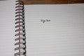 Sign here, handwriting text on page of office agenda, office spiral notebook. Copy space