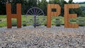 Sign for Hope Creatively Spelled on Fence