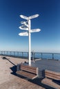 Sign indicating directions and distances to different cities of the world. The direction of the cities on the background of blue s Royalty Free Stock Photo