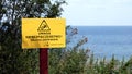 A sign informing about the danger and prohibiting entry in Polish on the beach of the Baltic Sea