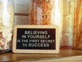Sign with an inscription believing in yourself is the first secret to success on the kitchen shelf. Royalty Free Stock Photo