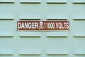 A sign with the inscription danger 11000 volts Royalty Free Stock Photo