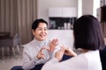 Sign language specialist talking with elderly patient deaf hearing and showing hand gestures