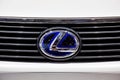 Sign of Lexus logo on white car